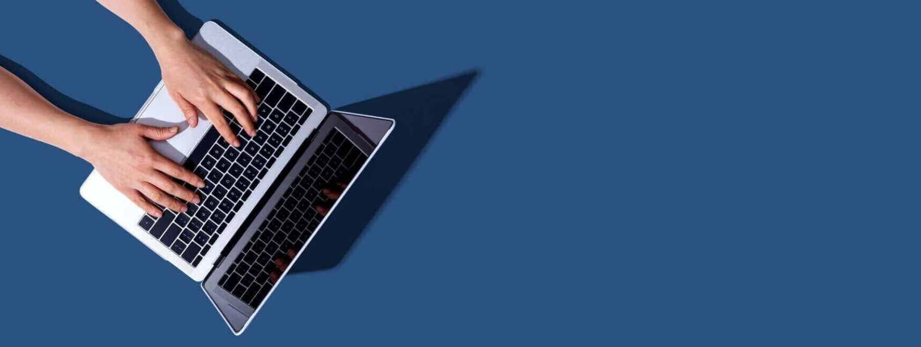 master-blue-banner-2-hands-typing-on-computer-representing-booking-free-consultation-with-ConexisVMS-banner-1800-760-47